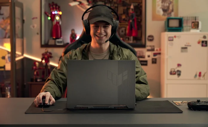 Gamer at a table playing using a TUF Gaming laptop 