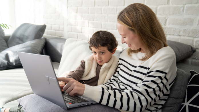 mother and child using laptop together
