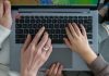 A family's hands on top of a laptop keyboard