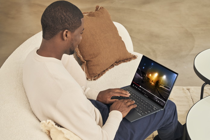 Man using laptop on a couch