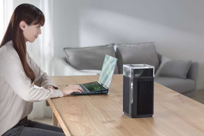 Woman using a laptop nearby a ZenWiFi mesh router