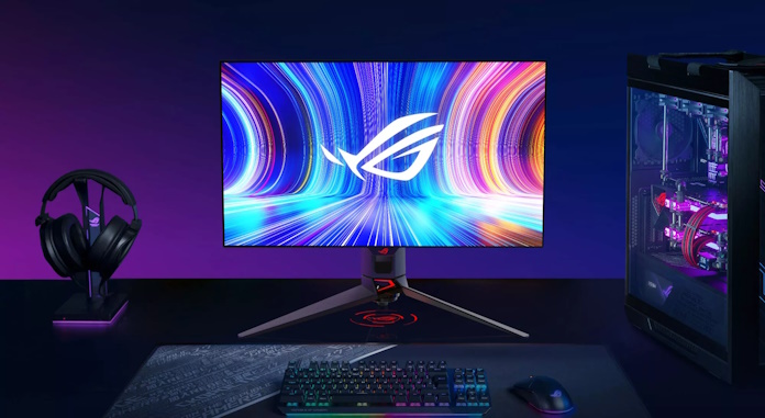 The ROG Swift OLED PG27AQDM display on a gaming desk with other ROG peripherals