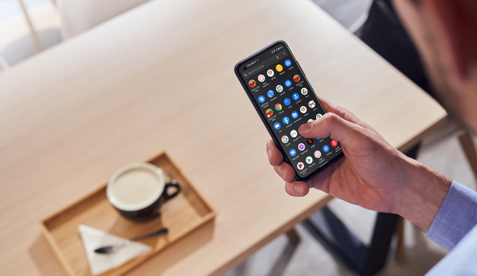 Business person using an ASUS smartphone in a coffee shop