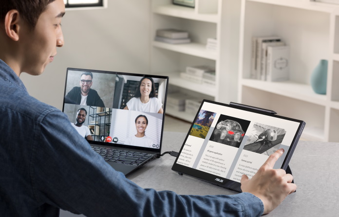 Man interacting with the touchscreen of his ASUS portable display