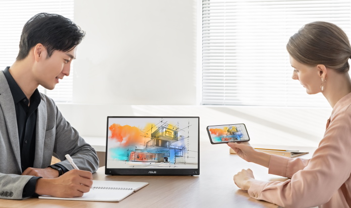 Man and woman looking at presentation on a portable monitor