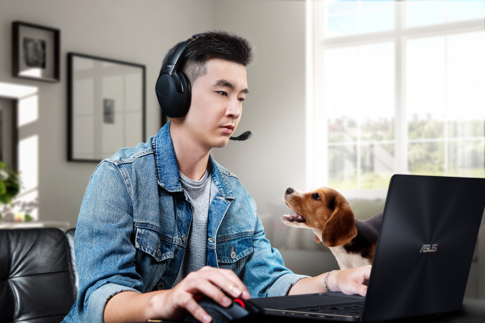 Dog barking at a man while he works from his home office