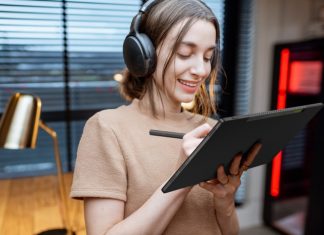 Young woman listening to music and working with a stylus on her Vivobook 13 Slate OLED