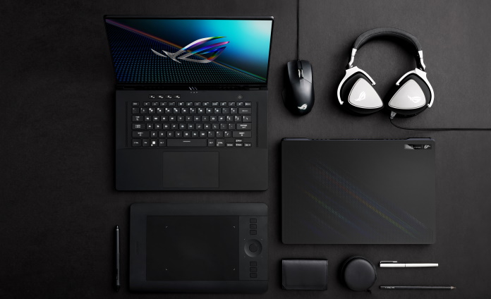 ROG Zephyrus M16 gaming laptop open on a table with other accessories for gaming and content creation