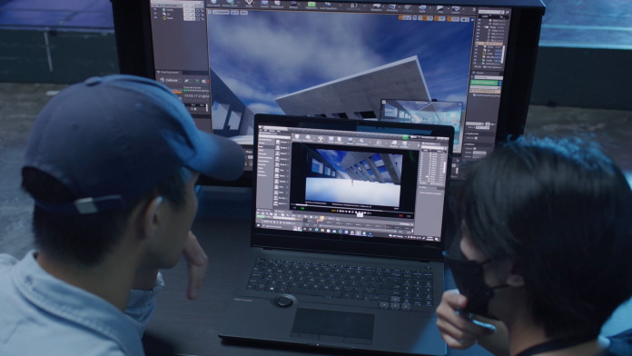 Two MoonShine designers using a ProArt Studiobook laptop and ProArt Display 