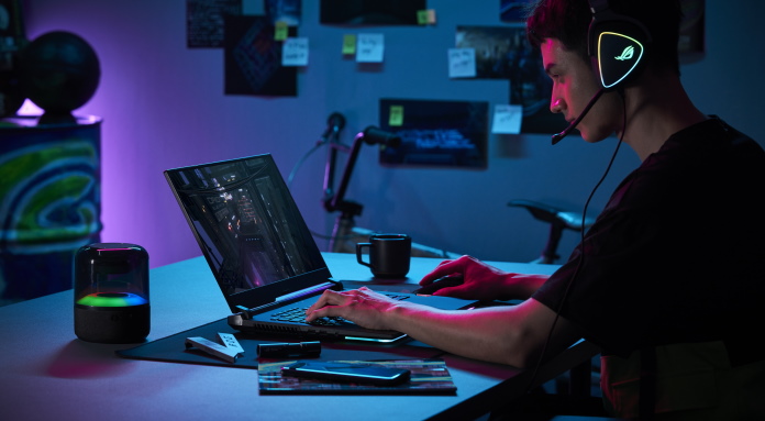 Young man gaming in his room using the ROG Strix SCAR 17