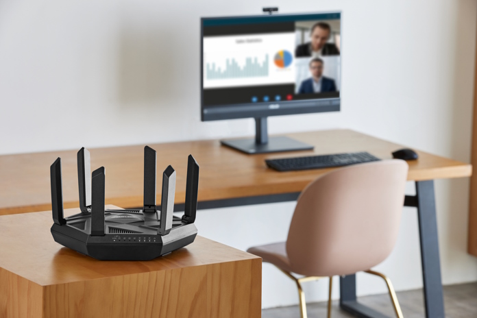 ASUS RT-AXE7800 wireless router on a table in a hybrid work scenario