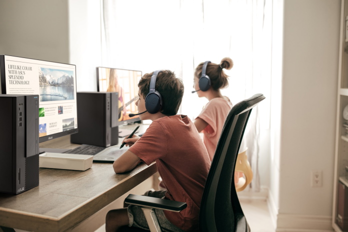 Two children working side-by-side on classwork