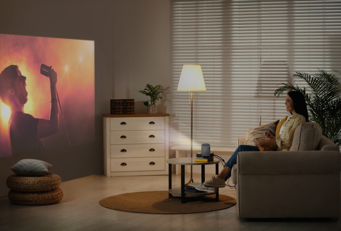 Woman watching a concert video in her home with the ZenBeam Latte L1 projector