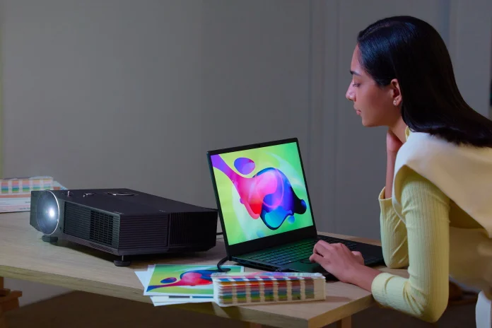 Woman displaying a colorful creative project using the ProArt Projector A1
