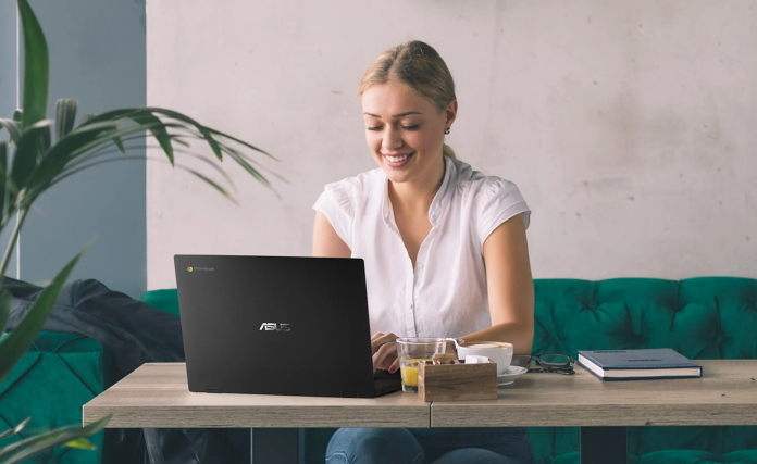 Woman using a Chromebook while sitting on a sofa