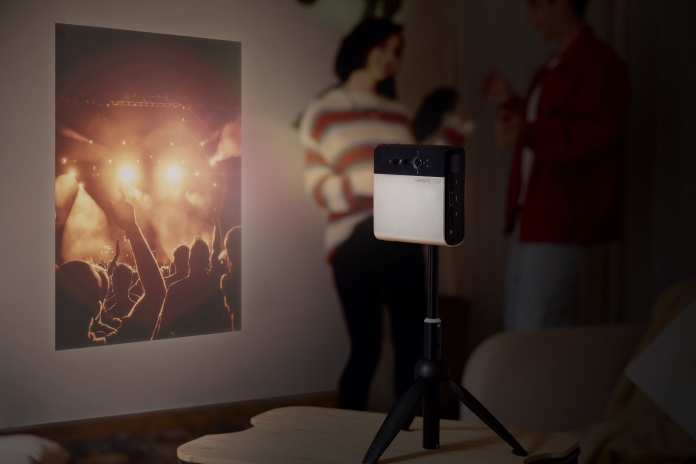 ZenBeam E2 projector displaying a video for a group of young people