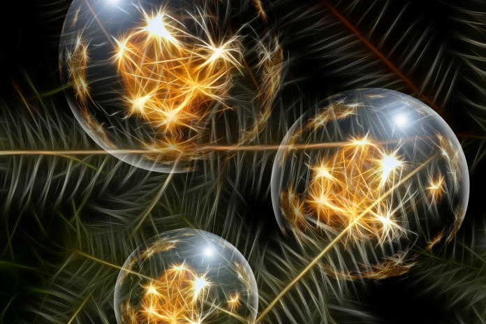 Christmas ornaments reflecting light on a fir tree