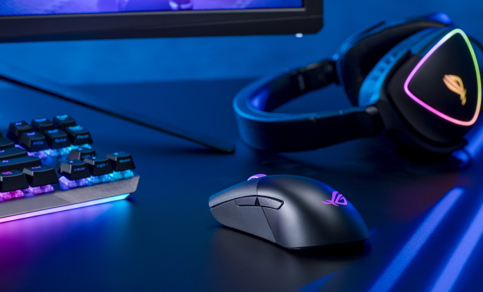 ROG Keris Wireless gaming mouse on a desk alongside an ROG headset and keyboard