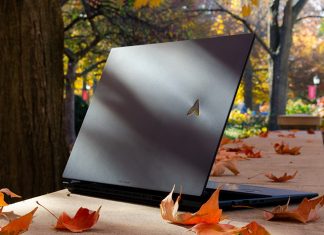 Zenbook Pro laptop on a stone retaining wall with autumn leaves scattered around