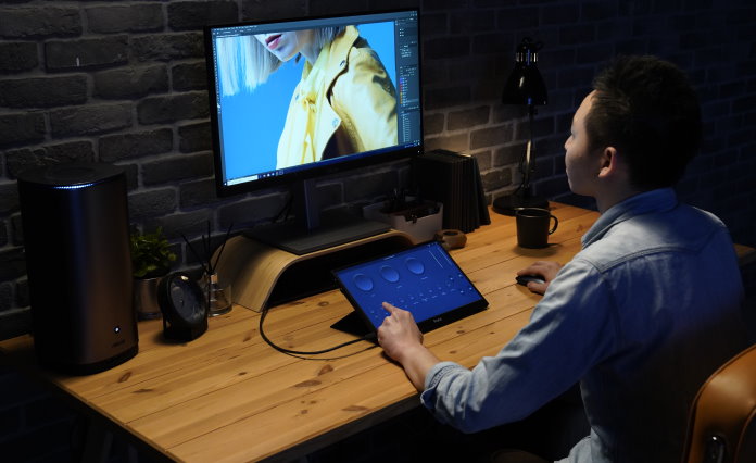 Young man editing a photo using the virtual Control Panel interface on his ProArt Display PA148CTV