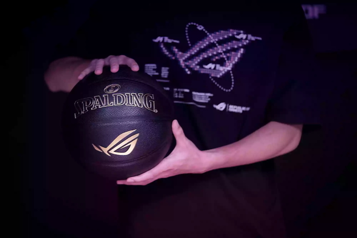 Gamer in an ROG shirt holding the ROG x Spalding Basketball