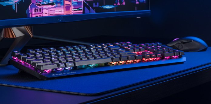 ROG Strix Scope RX keyboard on a desk with a monitor and the ROG Chakram mouse 