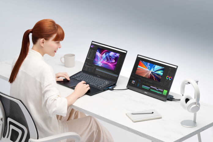 Woman using 2023 Zenbooks and an ASUS portable monitor for video editing