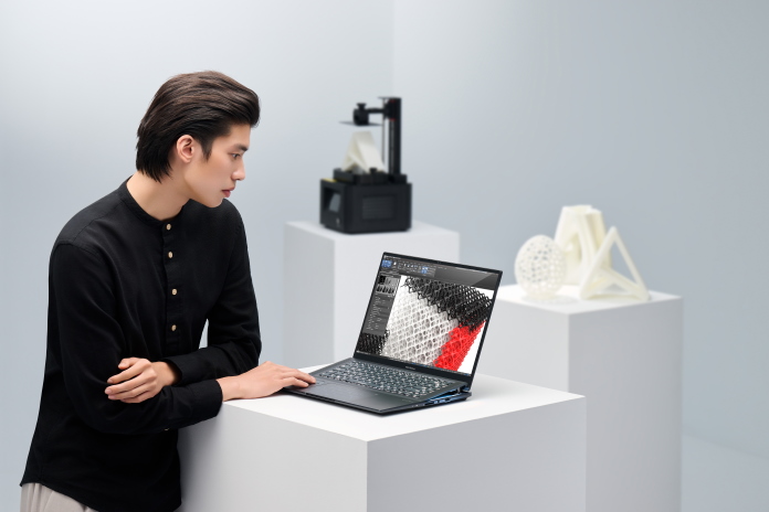 A young man doing photo editing work on the Zenbook Pro 16X OLED creator laptop