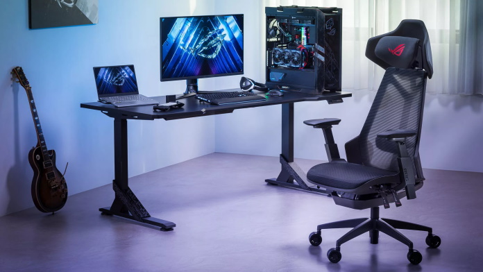 ROG Destrier at a gaming desk complete with desktop, monitor, laptop, and peripherals from ROG