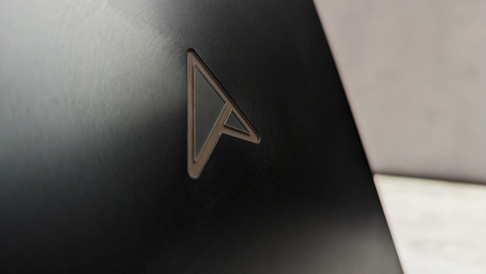 Closeup view of the ASUS monogram on the lid of the Zenbook Pro 16X OLED laptop 