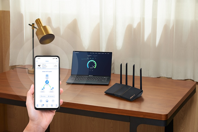 ASUS extendable router on a table with other living room decorations