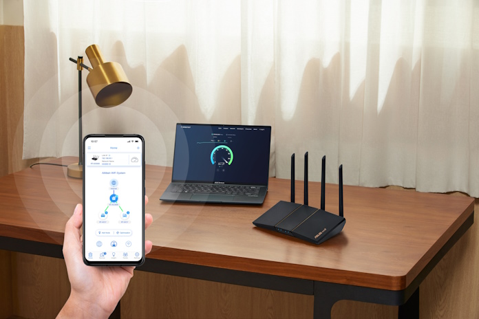 A person holding a smartphone with the ASUS Router App on it, showing how AiMesh works in their home