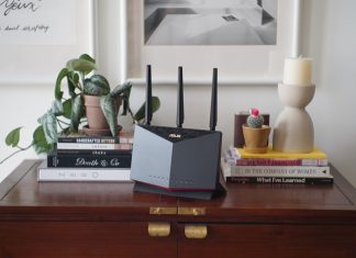 ASUS extendable router on a table with other living room decorations