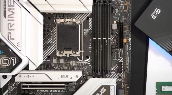 ASUS Prime motherboard laying on a table with DDR5 RAM DIMMs nearby