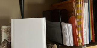 ASUS ZenWiFi XT9 mesh WiFi system on a bookshelf