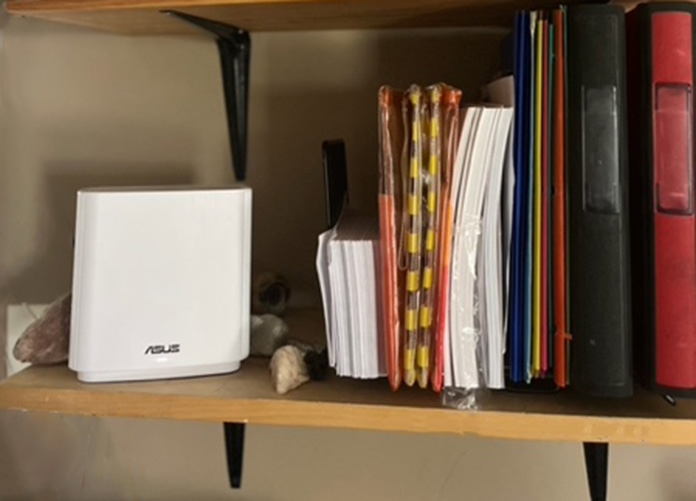 ASUS ZenWiFi XT9 mesh WiFi system on a bookshelf