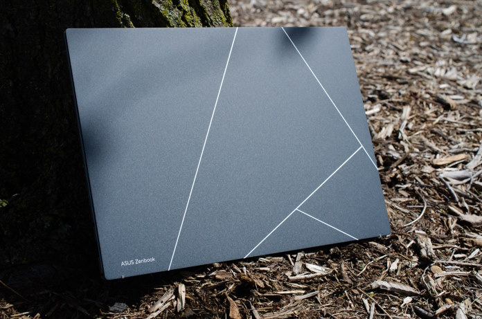 Zenbook S 13 OLED leaning against a tree trunk