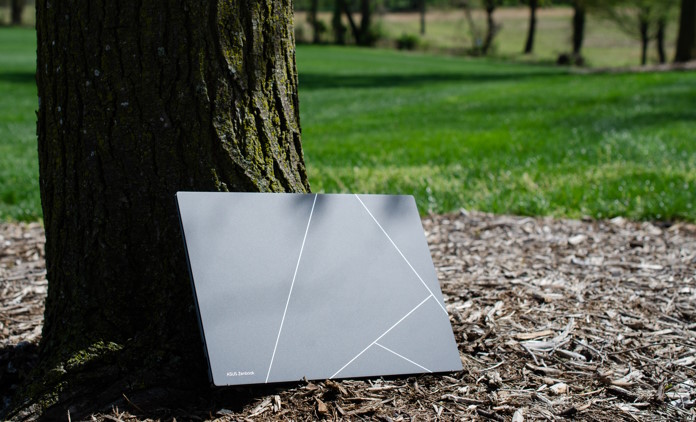 Zenbook S 13 OLED leaning against a tree trunk