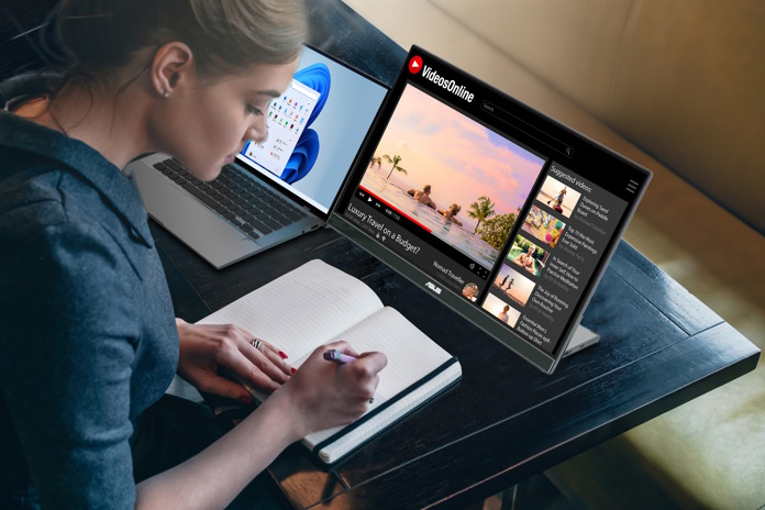 Young woman using a ASUS ZenScreen portable monitor to watch a video and take notes