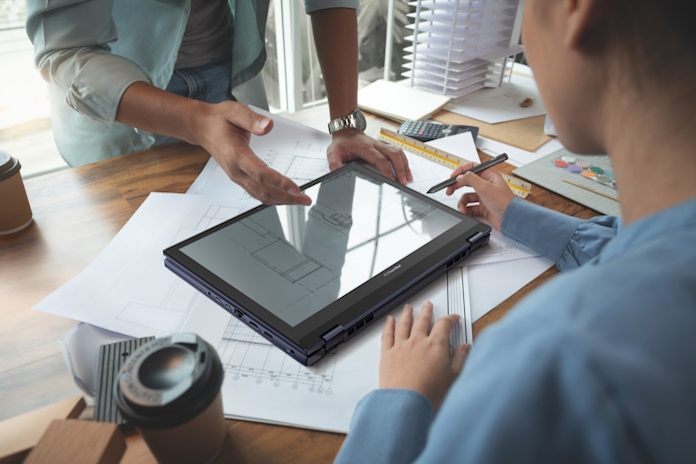 Two workers collaborating on an architecture project with the ExpertBook B6 Flip laptop