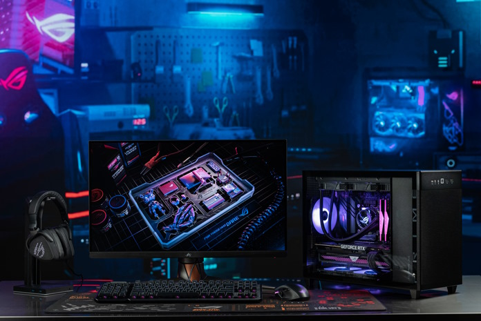 A complete gaming PC on a desk including a monitor, peripherals, and the ASUS Prime AP201 