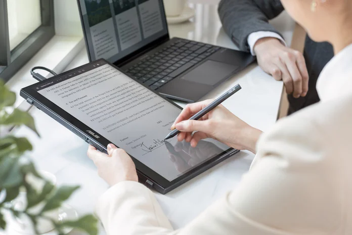 A portable monitor being used for signing business documents