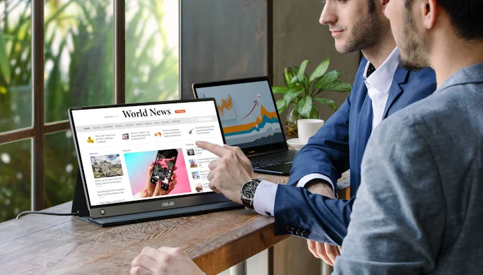 Two young men looking at a presentation together using a ZenScreen portable monitor