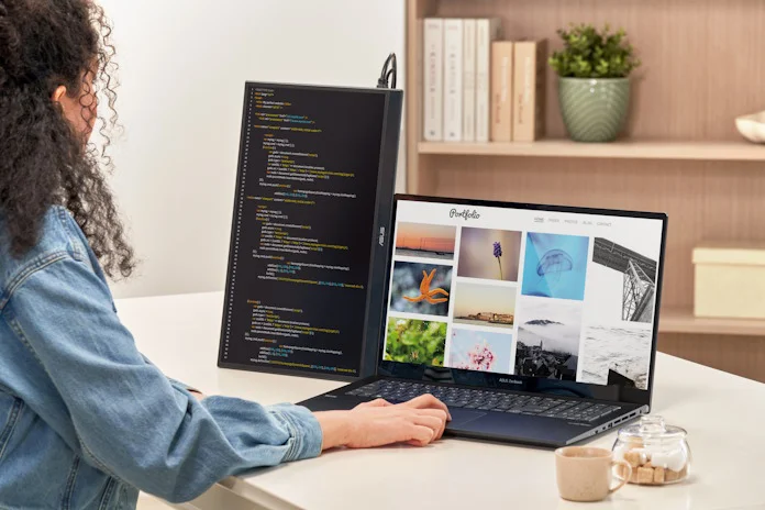 An ASUS ZenScreen portable monitor in vertical format used for coding