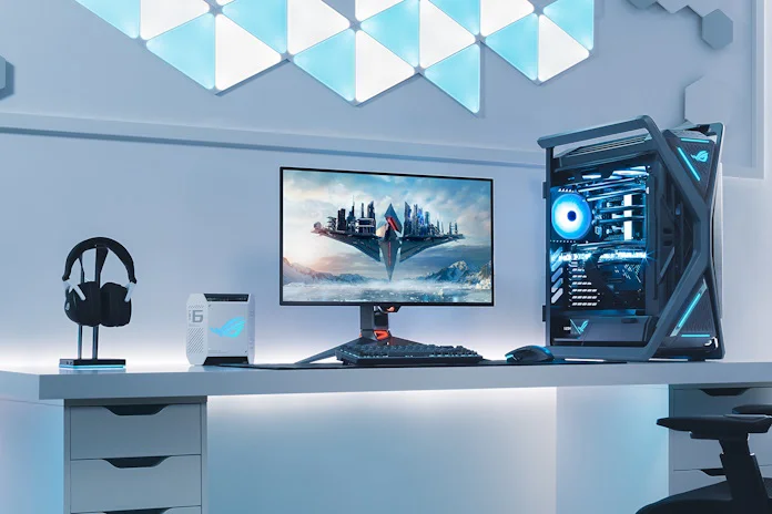 A full ROG gaming setup on a desk with an ROG gaming monitor at the center