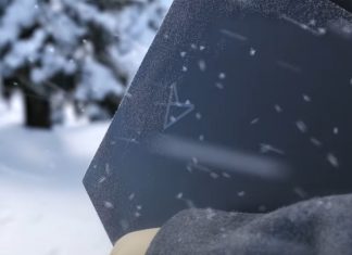 An ASUS laptop being carried on a cold and snowy day