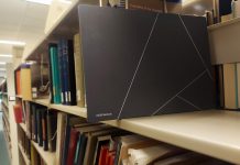 Zenbook S 13 OLED laptop on a bookshelf in a college library