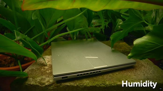 An ASUS laptop undergoing a military grade durability test to assess its resistance to humidity