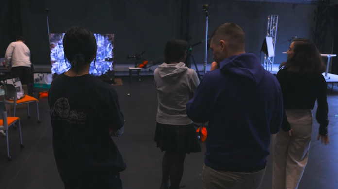 A group of students in a college video production lab