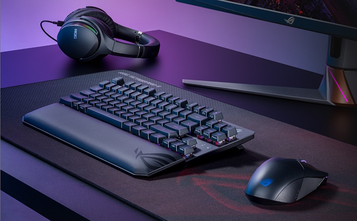 ROG Strix Scope RX TKL Wireless Deluxe gaming keyboard on a desk with other ROG gaming peripherals